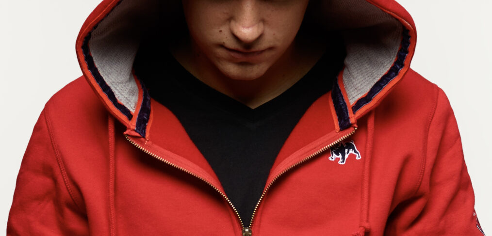 Young man wearing a Bulldog Factory hoodie featuring an embroidered bulldog logo